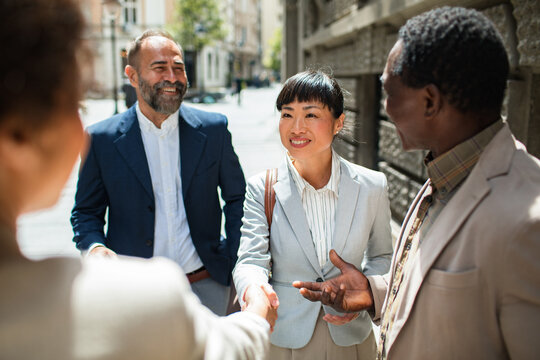 Group of businesspeople walking and talking in the city