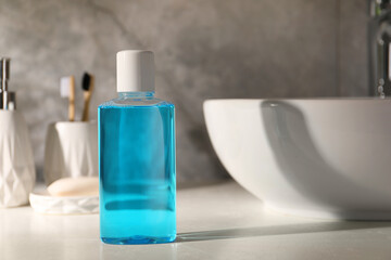 Bottle of mouthwash on light countertop in bathroom