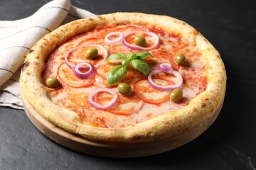 Delicious vegetarian pizza on black table, closeup