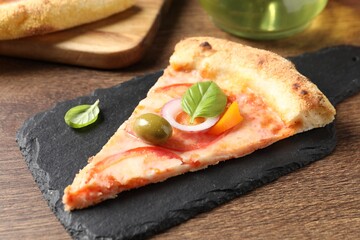 Slice of delicious vegetarian pizza on wooden table, closeup