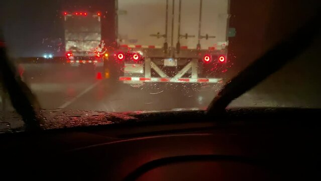 Windshield wipers of vehicle moving rain from window in storm 4k
