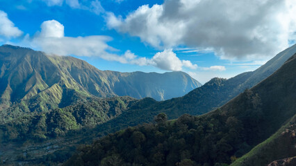 Fototapeta premium green hills, peaks of Pergasingan hills around Mount Rinjani. its landscape for hiking and outdoor lifestyle concept. beautiful natural scenery