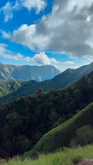 Fototapeta premium green hills, peaks of Pergasingan hills around Mount Rinjani. its landscape for hiking and outdoor lifestyle concept. beautiful natural scenery