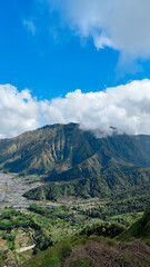 green hills, peaks of Pergasingan hills around Mount Rinjani. its landscape for hiking and outdoor lifestyle concept. beautiful natural scenery