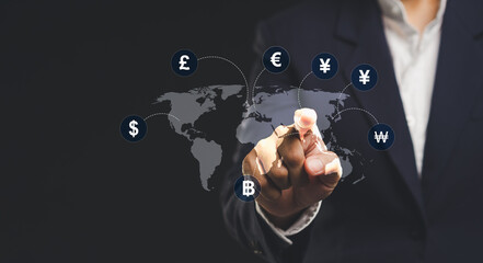Businessman touches a world map and currency signs for technology,currency exchange,and money transfer on a virtual screen.