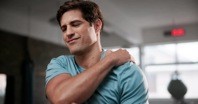 Frustrated man, shoulder and injury with pain at gym for accident during workout, exercise or training. Male person with sore ache, joint or inflammation from muscle tension or strain at health club