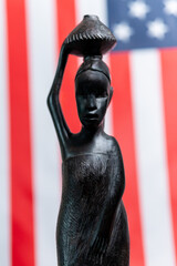 A Legacy in Wood: African Woman Under the Stars and Stripes