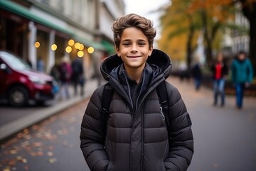 Fototapeta premium Portrait of a handsome young man smiling at the camera in the street