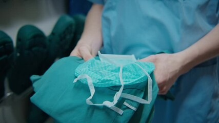 Hands of a young doctor holding the uniform - Powered by Adobe