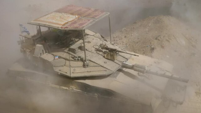 Israeli combat vehicle tanker Merkava driving through concrete rubble and dust remains of Gaza in war between Israel and Hamas