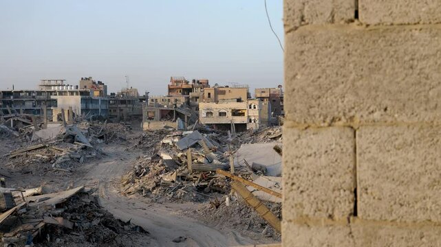 Establishing war footage of ruined Palestinian city destroyed buildings, view through the window