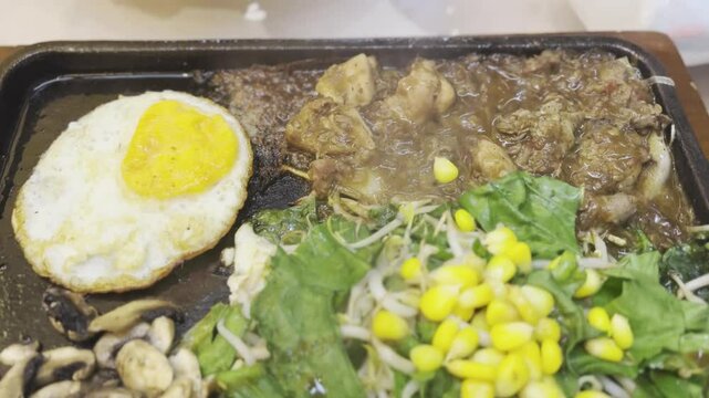 a very delicious mixed beef and chicken teppanyaki dish at a Japanese restaurant