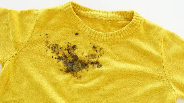  dirty mud stain on a yellow color child cloth 