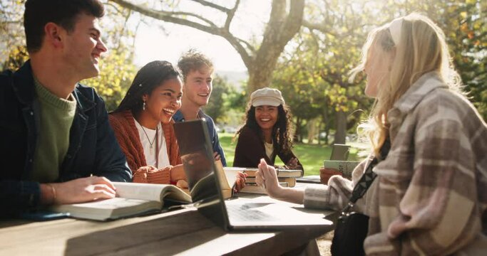 Students, laptop and conversation in park for study with books and learn for english assessment or test. Computer, gen z people and friends laughing outdoor for college education and knowledge