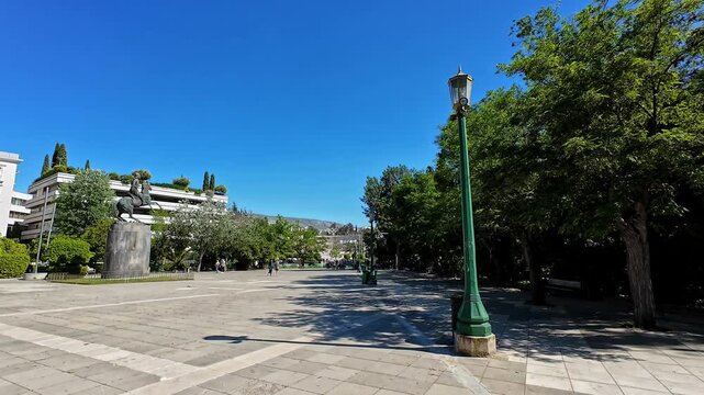 Walkway of Athens National Gardens on warm sunny day, dolly forward