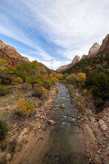 The aweinspiring view of a river meandering through Zion National Park in Utah features remarkable rock formations and verdant foliage, creating a truly magnificent and breathtaking sight to admire