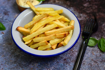  Home made   Fresh fried French fries  in a bowl on wooden rustic  background