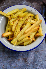  Home made   Fresh fried French fries  in a bowl on wooden rustic  background