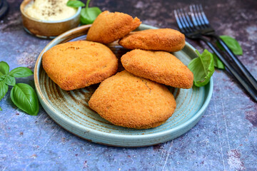  Crispy  deep fried home made     chicken Cordon bleu with cheese   and ham  and french fries on wooden rustic background.  
