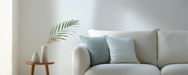 A cozy living room with a modern sofa, stylish decor, and a large window letting in natural light, showcasing contemporary interior design