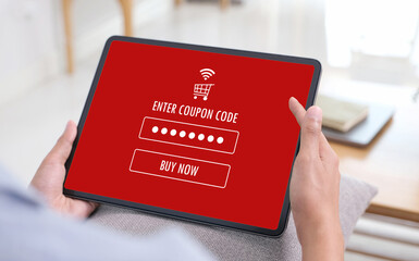 Hand typing discount coupon code on laptop screen to get the shopping on line cyber monday promotion, on line shopping ,digital marketing business and technology, lifestyle concept