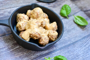 Homemade Swedish Meatballs  With creamy gravy sause in black pan skillet.Swedish cuisine.