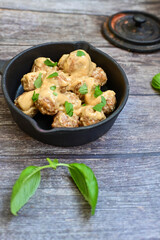 Homemade Swedish Meatballs  With creamy gravy sause in black pan skillet.Swedish cuisine.