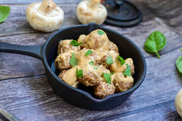 Homemade Swedish Meatballs  With creamy gravy sause in black pan skillet.Swedish cuisine.