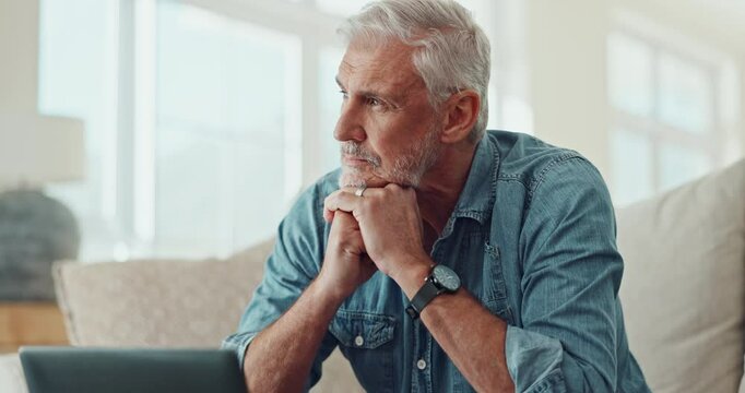 Mature man, home and thinking on laptop for business investment, decision and bankruptcy stress on sofa. Person, trader or investor with online risk, mistake or worried for investment on computer