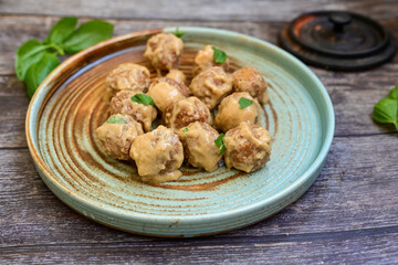 Homemade Swedish Meatballs  With creamy gravy sause in black pan skillet.Swedish cuisine.