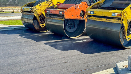 Rollers roll or lay new or fresh asphalt