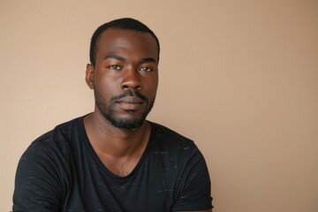 Fototapeta premium portrait of adult Black man looking at camera in studio
