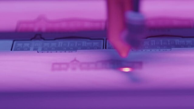 Close-up of laser printer engraving patterns. Media. Dot laser engraves patterns in robotic printer. Laser printers for fine engraving on any material