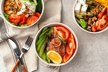 Beautiful composition with poke bowls on gray background with napkin