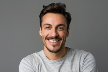 Fototapeta premium Portrait of attractive glad cheerful man over neutral background