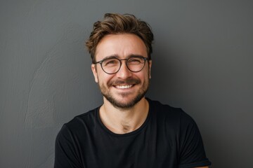 Obraz premium Portrait of attractive glad cheerful man over neutral background