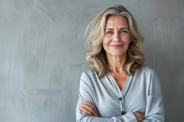 Portrait of confident smiling middle aged woman with crossed arms