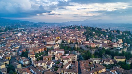 Obraz premium Scenic aerial view of Bergamo city northeast of Milan on cloudy evening Flying over Citta Alta towns upper district encircled by Venetian walls Bergamo Lombardy Italy : Generative AI