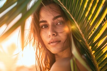 portrait of summer girl under palm leaves during sunset