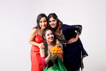 Indian Woman Models Posing In Indian Outfit While Holding A Laddu Plate