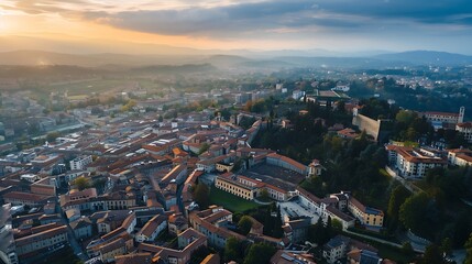Obraz premium Scenic aerial view of Bergamo city northeast of Milan on cloudy evening Flying over Citta Alta towns upper district encircled by Venetian walls Bergamo Lombardy Italy : Generative AI