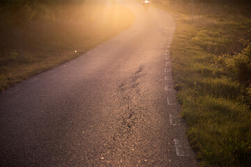 Scenic asphalt country road at sunset time