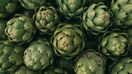 Fototapeta premium A close up view of fresh green artichokes in a market.