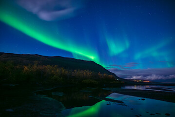 Monnlight lake with dancing of northern light in Abisko national park in north of Sweden