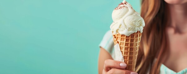A person holding a cone of ice cream. Free copy space for text.