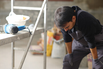 Fototapeta premium Exhausted construction worker resting