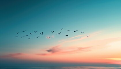 Obraz premium Birds flying in a beautiful sunset sky with a gradient of colors ranging from blue to orange and pink, creating a tranquil and serene scene.