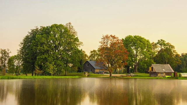 Long duration, all year, autumn through winter, spring, and summer time lapse of a cottage by a pond