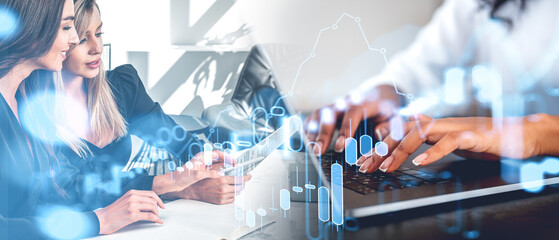 Business people reading papers and using laptop, forex diagram with candlesticks