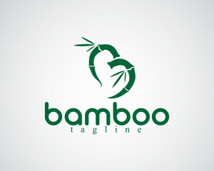 Creative two curved bamboos in the shape of love accompanied by leaves logo